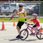 Sequim Gazette file photo by Michael Dashiell/
In May 2018, the Olympic Peninsula Bicycle Alliance (OPBA) held its first Bike Rodeo for children. Pictured is course designer Brian Watson helping Eleanor Jones with the figure eight component of the course. OPBA board members recently voted to disband the group and distribute its funds to eight area nonprofits. Sequim Cub Scout Pack 4490 received a grant and equipment to continue the Bike Rodeo.