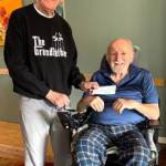 Photo courtesy OPBA/
Tom Coonelly with the Olympic Peninsula Bicycle Association (OPBA) presents Ron Adler with the OTA Singers through Olympic Theatre Arts a grant worth $3,969. The OPBA has disbanded and board members agreed to distribute its remaining funds equally to eight area nonprofits. Adler is an avid cyclist who sustained injuries in a cycling accident in May and was paralyzed from the chest down.