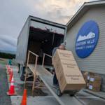 Photo courtesy Operation Christmas Child/ John Schvetz, central drop-off coordinator, hauls cartons of shoebox gifts into a truck headed for an Operation Christmas Child Processing Center, starting their journey to needy children around the world in 2024. He will do the same this year.