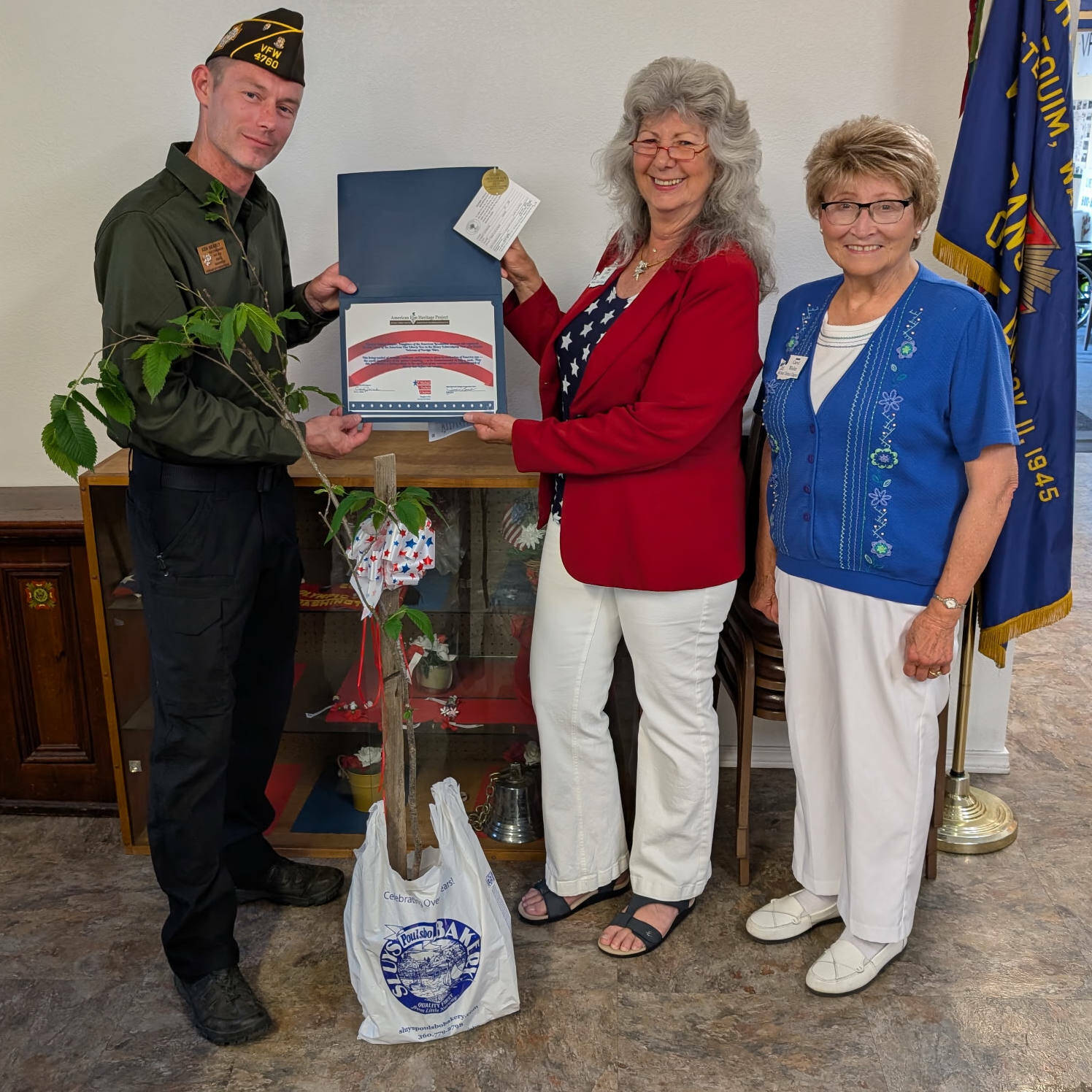 Photo courtesy Judy Tordini/ Ken Bearly, commander of Sequim VFW Post #4760, accepts the gift of a historic "Herbie" American Elm clone from Jamie Bent, center, historian for the Michael Trebert Chapter, DAR, and Regent Carol Weiler.