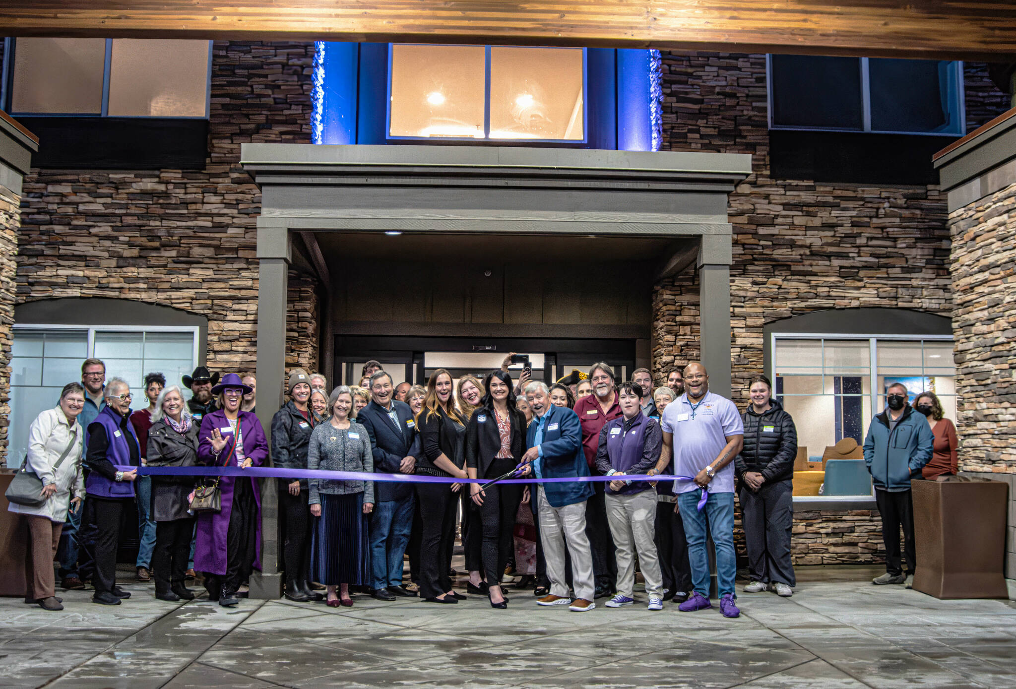 Photo by Time Catcher Photography/ The Holiday Inn Express and Suites at 1441 E. Washington St. received the royal treatment from the Sequim-Dungeness Valley Chamber of Commerce with a ribbon-cutting on Nov. 6 to mark the 15-year-old hotels grand re-opening after an extensive, six-month remodel. The 77-room hotel now boasts shades of light blue and gray to symbolize water and the nature photos of local photographer John Gussman, including a 180-degree picture of the Olympic Mountains inside the elevators.