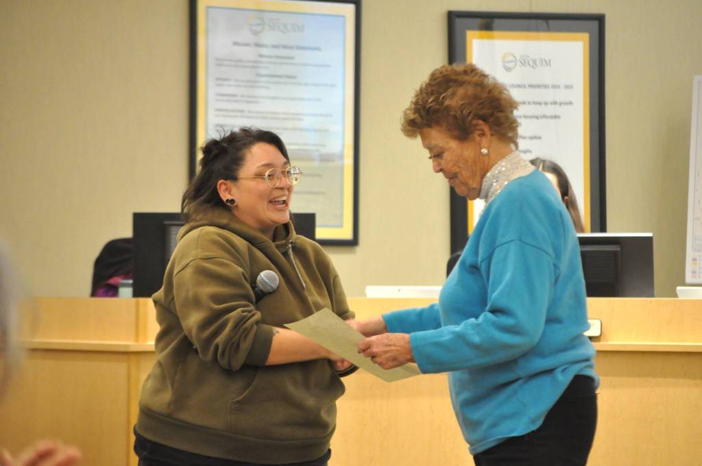 Sequim Gazette photo by Matthew Nash/
Sequim Deputy Mayor Rachel Anderson hands Emily Westcott a copy of a proclamation honoring her decades of community service.