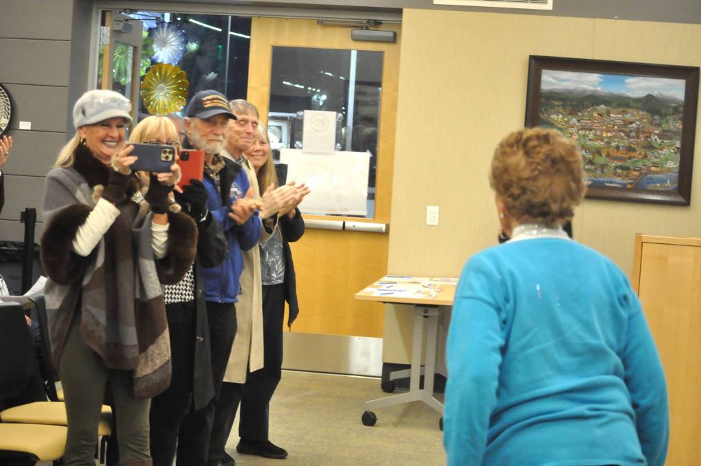 Sequim Gazette photo by Matthew Nash/
Friends and audience members of the Sequim City Council Nov. 10 meeting applaud Emily Westcott for her service to the city with Christmas decorations, flower baskets, and beautification efforts.