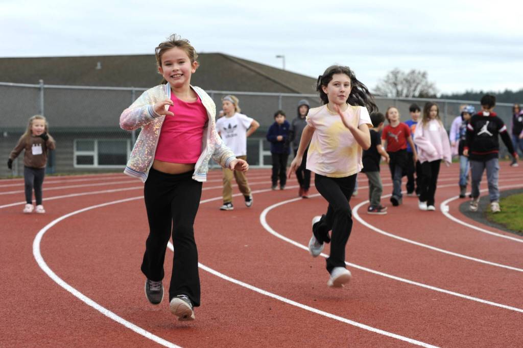 Third graders Everly Catelli and Stella Tweten zip by during the Turkey Trot.