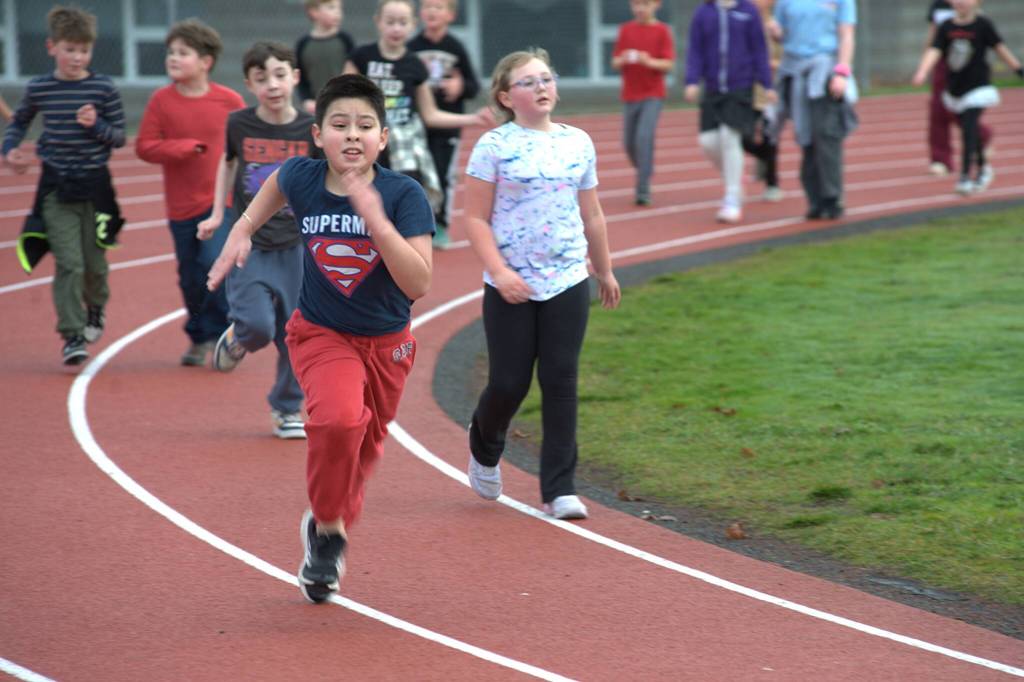 Julio Hernandez, a fourth grader at Helen Haller Elementary, runs hard to finish his last lap of the Turkey Trot.