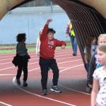 Sequim Gazette photo by Matthew Nash/
Jason Hadley does a skip jump through the inflatable Sequim Wolf during the Turkey Trot with fellow Helen Haller Elementary students.