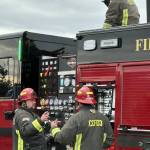 Photo courtesy CCFD3
Captains Jeff Albers and Travis Anderson with Clallam County Fire District 3 discuss training on a new fire engine while Firefighter Ryan Hueter loads a hose.