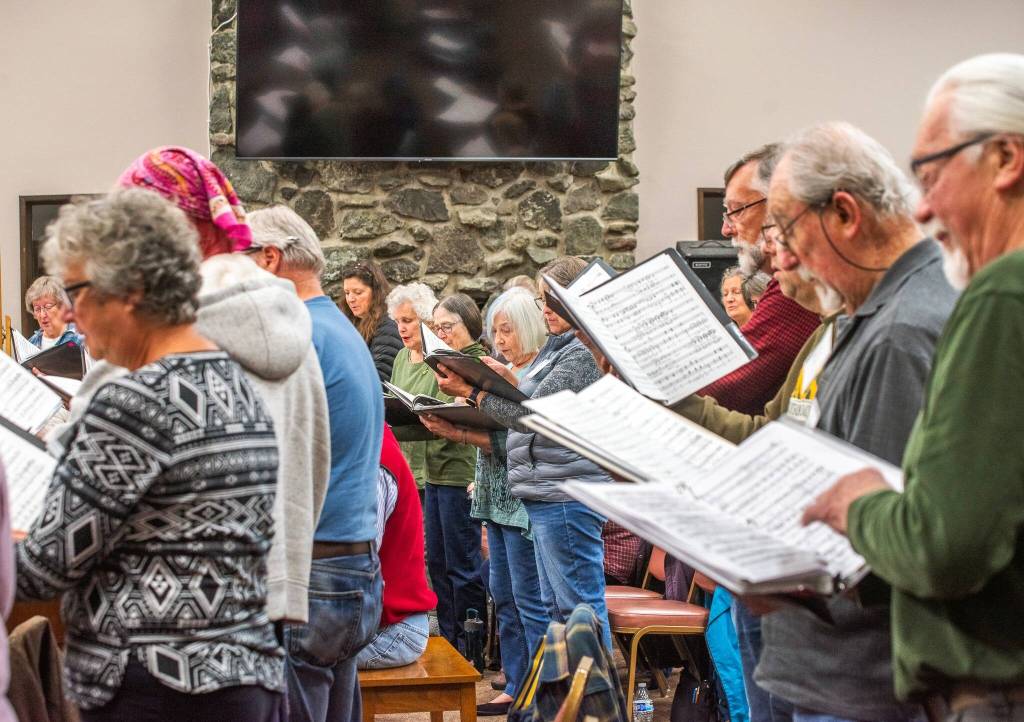 Photo by Emily Matthiessen/
Singers in the Sequim Community Christmas Chorus rehearse for the concert The Ages of Christmas, to be performed this Friday, Saturday and Sunday at the Sequim Seventh-day Adventist Church. This sacred music concert takes listeners on a trip through Christmas music history beginning in 990 AD and includes guest instrumentalists and sing-alongs.