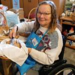 Photo courtesy Kyra Humphrey/ Kyra Humphrey serves up fresh scones made by her husband for the Christmas Cottage Holiday Bazaar and Bakery-Cafe hosted by the Sequim Guild for Seattle Childrens Hospital.