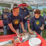Sequim Gazette file photo by Emily Matthiessen/ Sequim Valley Lions Club members Vanessa Mills, Stan Dame and June Nicholas prepare plates of Dungeness Crab at the 12th Annual Crab Feed in Pioneer Memorial Park in June 2025.