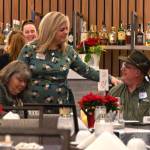 Sequim Gazette photo by Monica Berkseth
Sequim Valley Lions Club marketing chair Cely Alhaddad greets attendees at the Saturday, Dec. 6 event at 7 Cedars commemorating the nonprofits 70th anniversary.