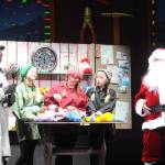 News reporter Andy Anderson (Greg Bova) interviews Santa (Joel Swenning) at the North Pole as elves Finky (Arwen Osborne), Winky (Rayna Buggy), and Stinky (Rain Nelson) make toys.