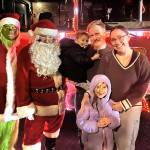 Sequim Gazette photo by Matthew Nash
The Grinch and Santa Claus take a photo with the Orr family - Jasper Orr, 5, dad TJ Orr, Charlie Orr, 8, and mom Lisa Orr - on Dec. 11 in Sunland during a stop for Santas Toy and Food Fire Brigade. Lisa Orr said they come out to visit Santa every year.