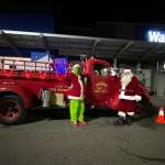 Photo courtesy Jeff Albers, CCFD3/
The Grinch and Santa Claus (John Brygider) stand outside Sequim Walmart on Dec. 12 after a week-long effort collecting toys, food and monetary donations with Santas Toy and Food Fire Brigade for Sequim Food Bank and Sequim Community Aids Toys for Sequim Kids.