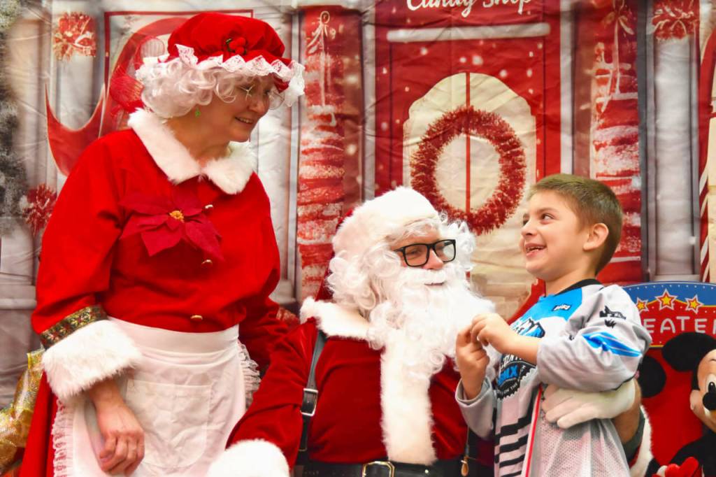 Sequim Gazette photos by Monica Berkseth
Santa and Mrs. Claus, who happen to be close friends with Marty and Michelle Bingham of Sequim, listen carefully to the Christmas wishes of Tanner Deemer, 7, during the Breakfast with Santa event hosted by The Church of Jesus Christ of Latter-Day Saints on Saturday, Dec. 13.<font face="Courier New, Courier, monospace" size="3">
</font>