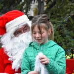 Sequim Gazette photo by Monica Berkseth/ Maeve Irick tells Santa what she wants for Christmas.