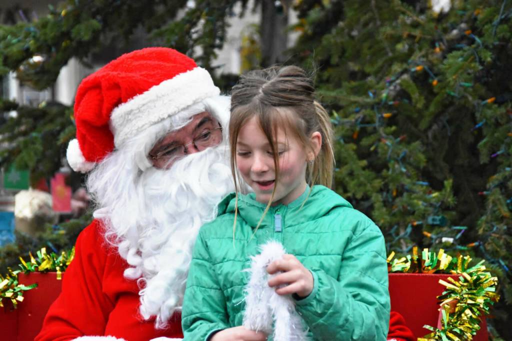 Sequim Gazette photo by Monica Berkseth/ Maeve Irick tells Santa what she wants for Christmas.