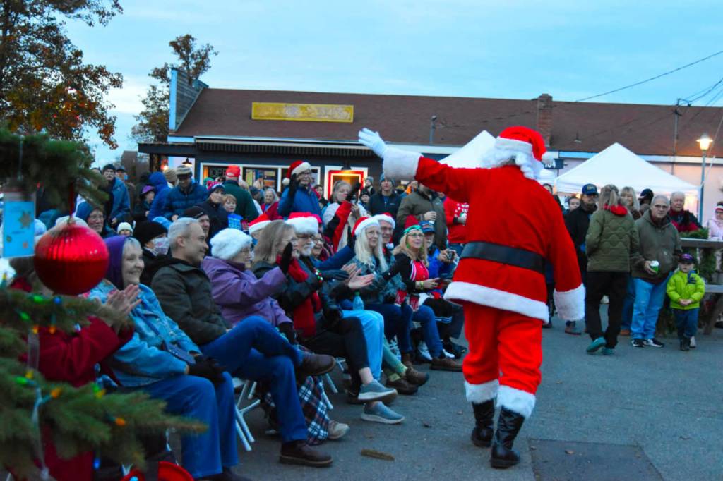 Sequim Gazette photo by Monica Berkseth/ Santa always receives a warm welcome during Sequims Hometown Holidays event, which kicks off the Christmas season.