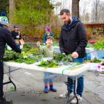 Sequim Gazette photo by Monica Berkseth/ Jon Alderson and his five-year-old son, Kadin, make wreath-making a father-son project during the Dungeness River Nature Centers annual Holiday Nature Mart.
