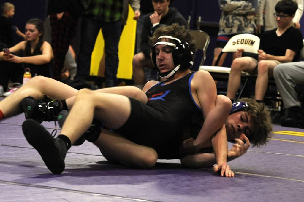 Sequim Gazette photo by Matthew Nash/
Sequims Carson Mead, on right, wrestles against Isaac Eades of East Jefferson on Dec. 11 and won by pin in 1:37.