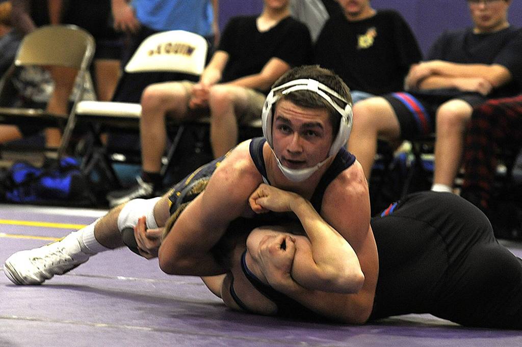 Sequim Gazette photo by Matthew Nash/
Sequims Riley Downs (144 pounds) pins East Jefferson Robby Evans in 2:24 during a head-to-head matchup on Dec. 11 in Sequim.