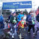Photo courtesy Michael Dashiell, Jamestown SKlallam Tribe
Aaliyah Clark of Poulsbo (378) and Monica Castleberry of Lacey (21) lead a young runner at the start of the Jamestown SKlallam Glow Run in Blyn on Dec. 6. The race had a record-breaking 900 participants this year.