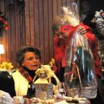 Randi Cooper, donations manager for the Sequim-Dungeness Hospital Guild, presents Emma Em Hutchins, a founding member of the guild, with a basket during the groups annual volunteer appreciation event.