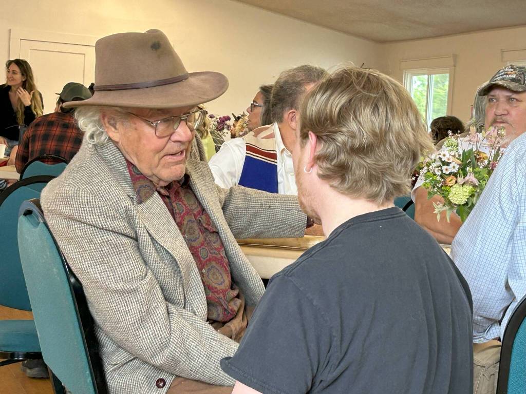 Sequim Gazette photo by Matthew Nash
The tribulations of Dungeness farmer Nash Huber made #2 on the Sequim Gazettes most read online stories of 2025. Huber  shown here greeting visitors during a May 17 benefit concert and dinner at Sequim Prairie Grange that raised funds for his medical and legal expenses  has faced eviction from Delta Farm by Washington Farmland Trust for alleged lease agreement violations. In an update to that situation, Washington Farmland Trust reports that the Hubers will vacate the farm in early 2026.