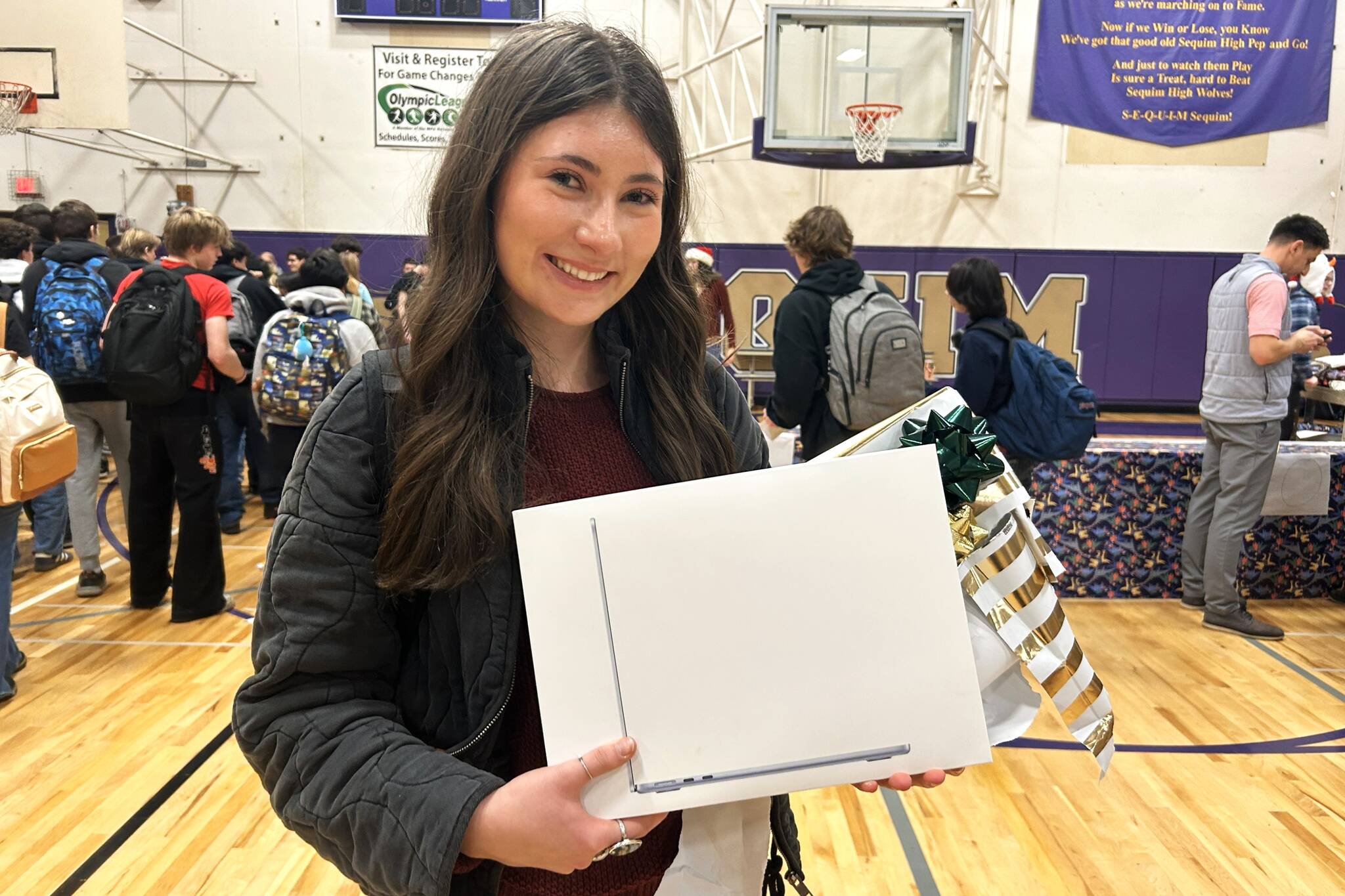 Sequim Gazette photo by Matthew Nash/
Kendra Dodson holds a new MacBook she received through the Winter Wishes assembly at Sequim High School on Dec. 16. Im just blown away by my teachers, she said. Our staff is very amazing. I feel very lucky.