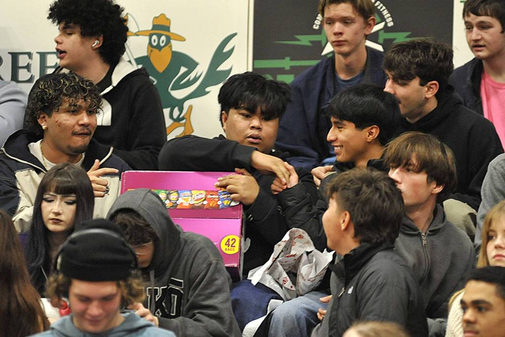 Sequim Gazette photo by Matthew Nash/
Friends of Grillien Morrill celebrate him receiving a box of chips during SHSs Winter Wishes assembly.