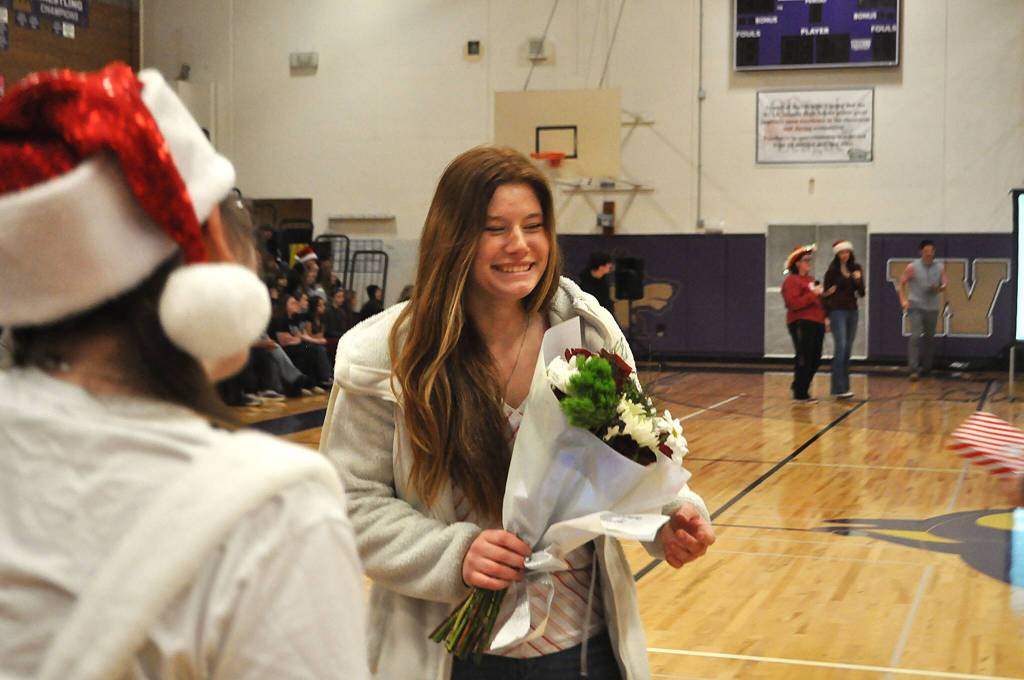 Kristine Prorok is thrilled to receive flowers as a gift through the ASB Leadership class at Winter Wishes.