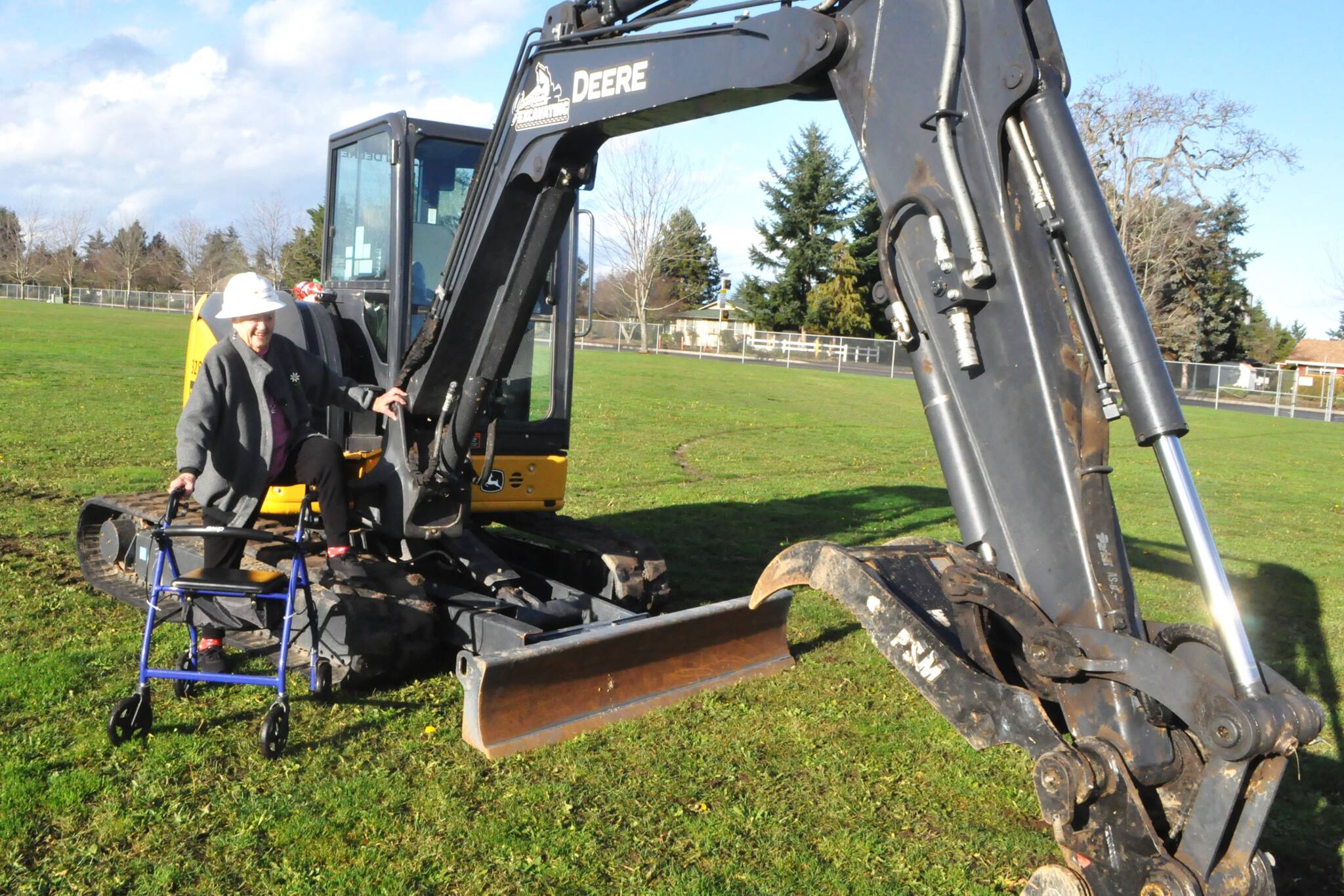 Marylaura Ramponi stands by an excavator donated for geotechnical work at Sequim School District by Jamestown Excavating on Dec. 15. She donated $1 million for the naming rights of the Ramponi Center for Technical Excellence, a career and technical education building that will be built in conjunction with new buildings at Sequim High School.