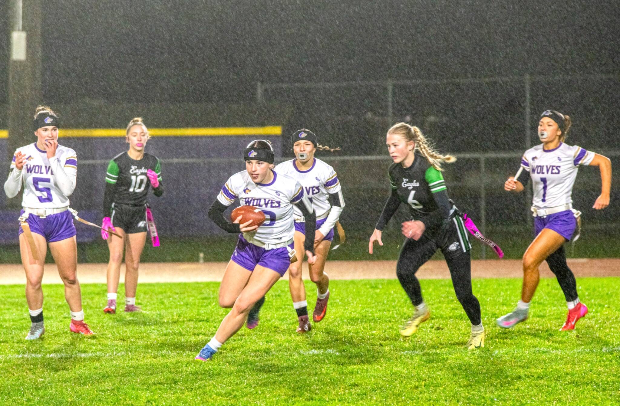 Photos by Emily Matthiessen
Sequims Stella Dennis runs with the ball during a wet and windy game against Port Angeles on Dec. 18. The Wolves won 37-6.