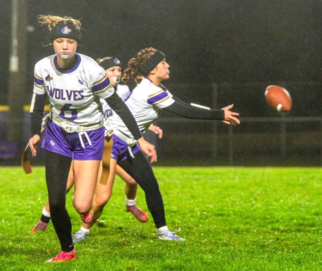Sydney Thomas-Harris receives the ball as Lily Sparks (6) and Kiley Winter, in background, await the play to commence against Port Angeles on Dec. 18 in Sequim.