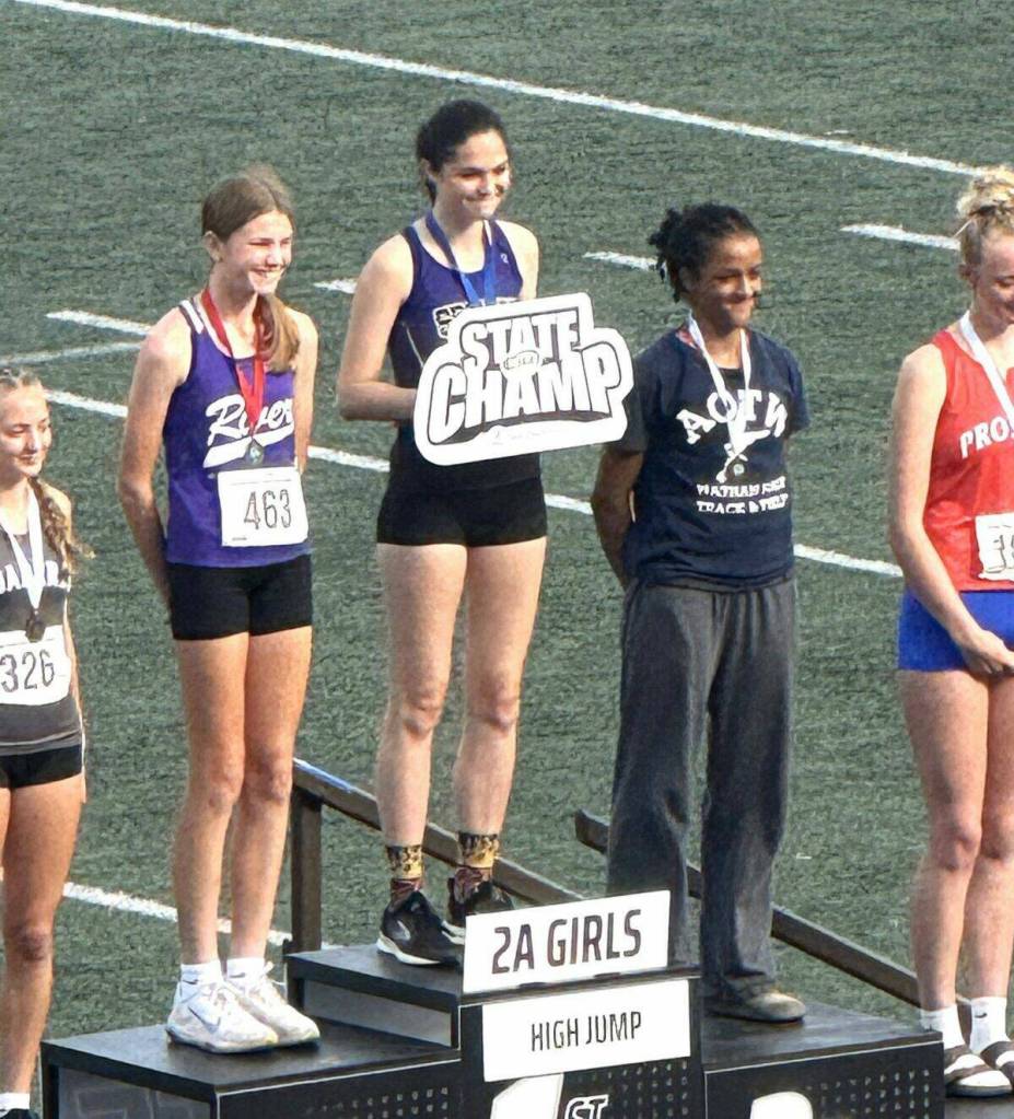 Photo courtesy Brad Moore/ Sequims Clare Turella receives a first place medal in the Washington state 2A track and field meet in Tacoma on May 30 after she jumped 5-4 to win the title this year. She jumped 5-2 in 2024 to win the title as a freshman.