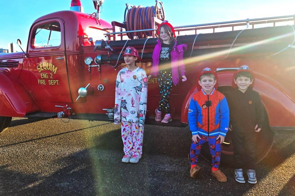 Photo courtesy Jennifer Lopez/ Greywolf Elementary students Kiera Hardin, Kacy Batson, Dean Lotzgesell and Axel Anstett ready to ride in a fire truck after school on Dec. 19. Batson and Lotzgesell were some of the top recipients for the Sequim Elementary PTAs Turkey Trot fundraiser.