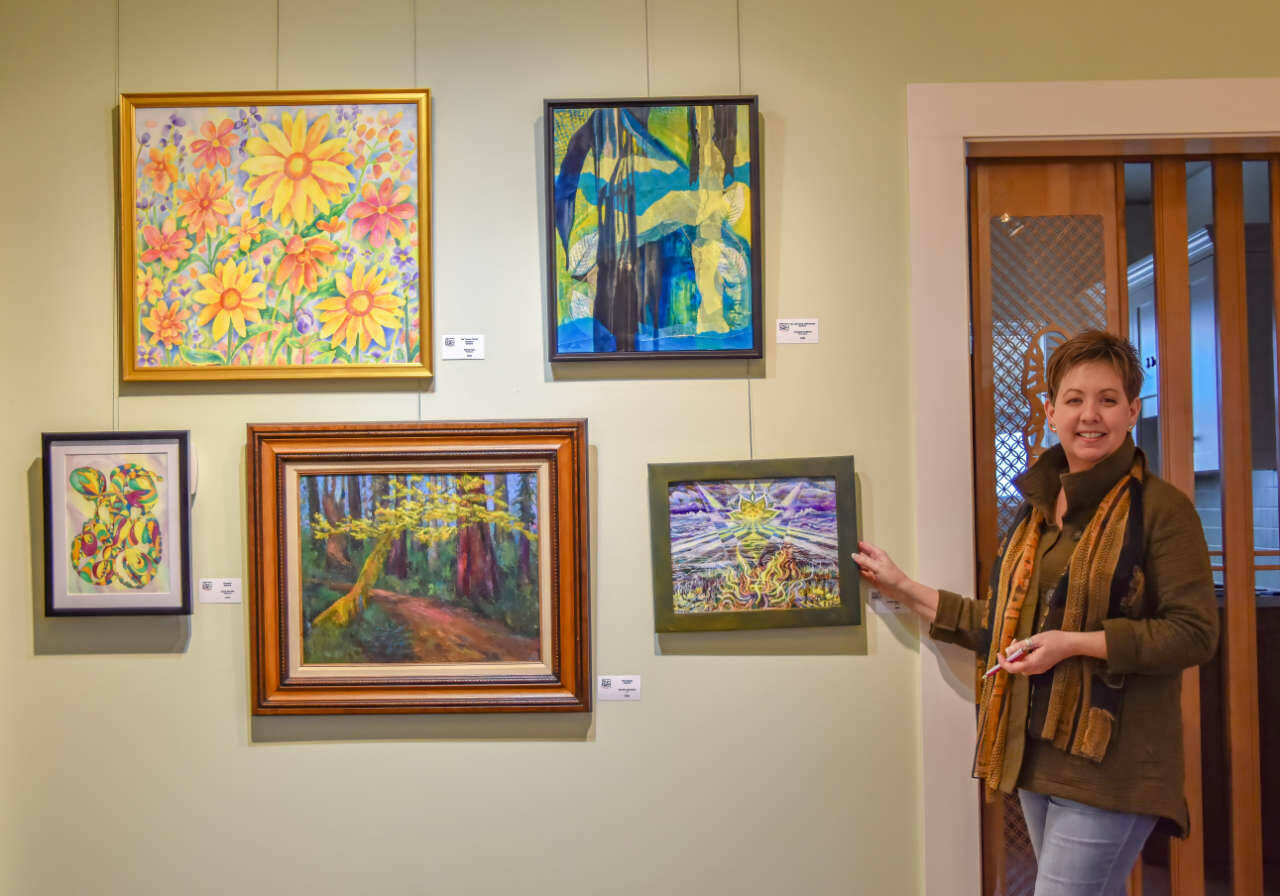 Sequim Gazette photo by Monica Berkseth
Anne Milligan, owner of A. Milligan Art Studio & Gallery at 520 N. Sequim Ave., stands near some of the pieces contributed by members of the Olympic Peninsula Art Association for a show to raise funds for art scholarships.