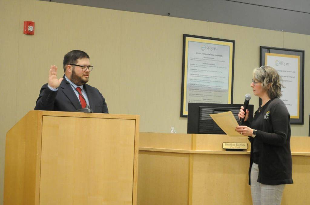 Sequim Gazette photo by Matthew Nash/
Brandon Janisse, Sequims mayor from 2024-2025, is sworn into office again as a city councilor by city clerk Heather Robley on Jan. 12.
