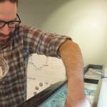 Photos courtesy Dungeness River Nature Center/ Dungeness River Nature Center Director Michael Glore drops coho salmon eggs into a tank. The river center recently received 500 coho salmon eggs from the Hurd Creek Hatchery for a seasonal educational exhibit.