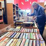 Volunteer Barbara Erler sorts books for the Friends of Sequim Librarys annex in the back of its storefront in Rock Plaza.