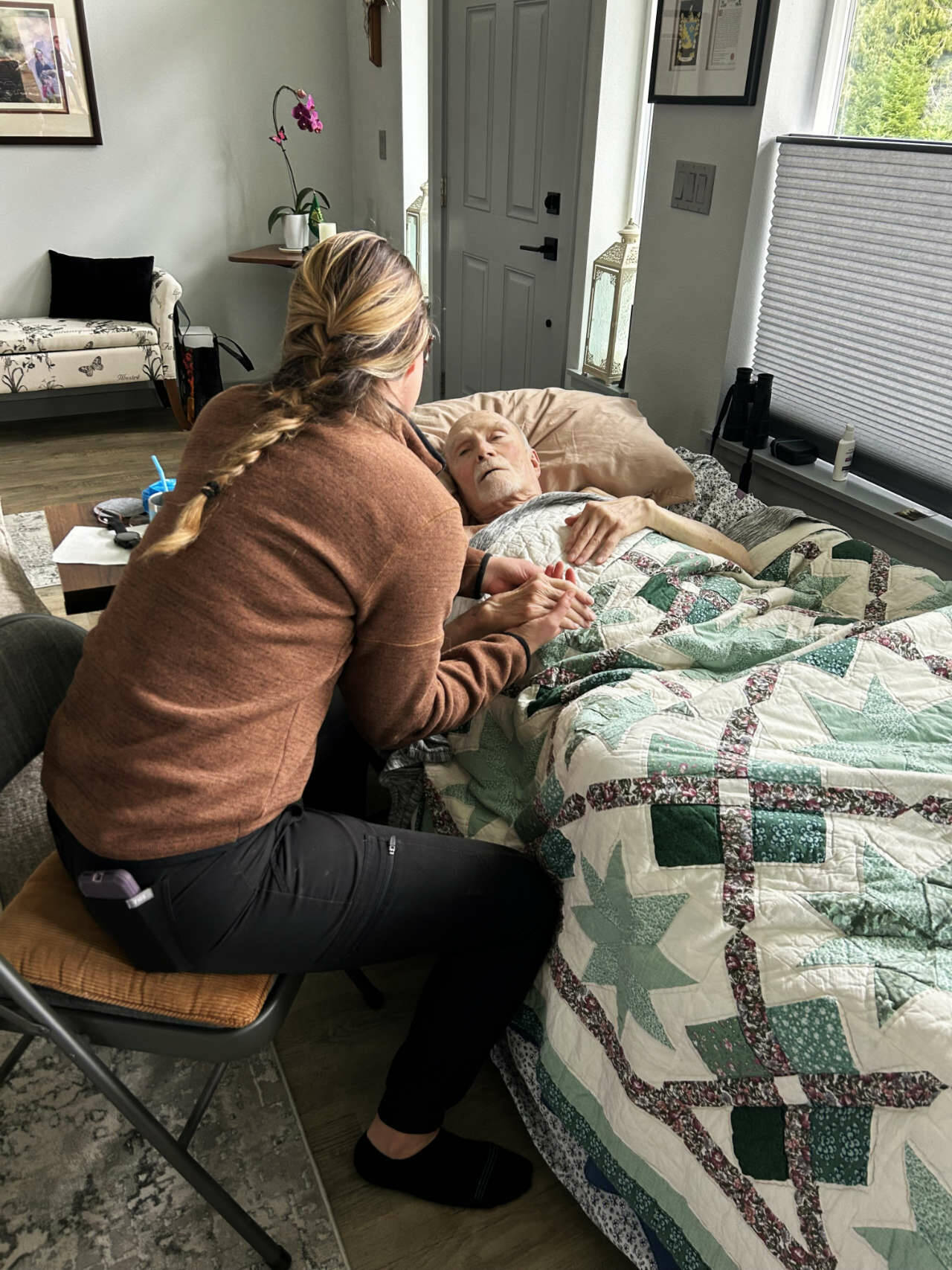 Photo courtesy Volunteer 
Hospice of Clallam County 
Becca W., a registered nurse who volunteers with Volunteer Hospice of Clallam County, comforts a patient. (The nonprofit does not divulge the full names of its volunteers. This photo was shared with permission from the patients family.)