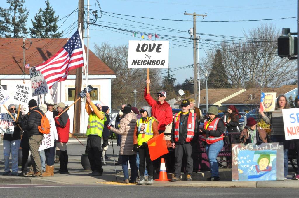 Sequim Gazette photo by Matthew Nash/
Locals hold signs up at the corners of Washington Street and Sequim Avenue during a peaceful protest on Jan. 25.