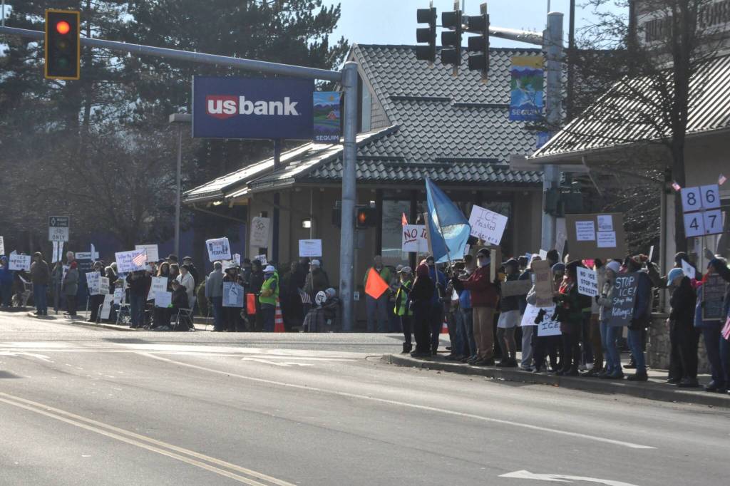 Sequim Gazette photo by Matthew Nash/
Locals hold signs up at the corners of Washington Street and Sequim Avenue during a peaceful protest on Jan. 25.