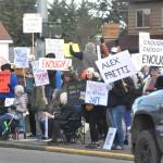 Sequim Gazette photo by Matthew Nash/ Locals hold signs up at the corners of Washington Street and Sequim Avenue during a peaceful protest on Jan. 25.
