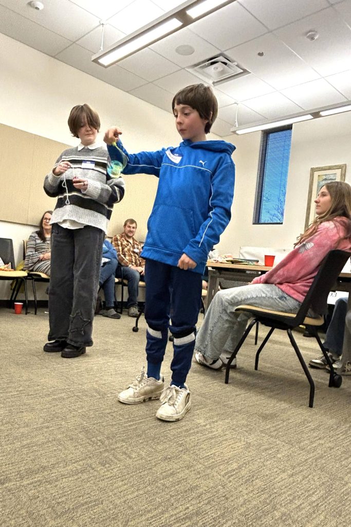 Sequim Gazette photo by Matthew Nash/
Sequim student Maddox Mansun yo-yos as fellow student Roo Yates watches during a virtual exchange with Shiso City students. Sequim and Shiso City sister city representatives mailed treats and traditional games to each other to share during the meeting.