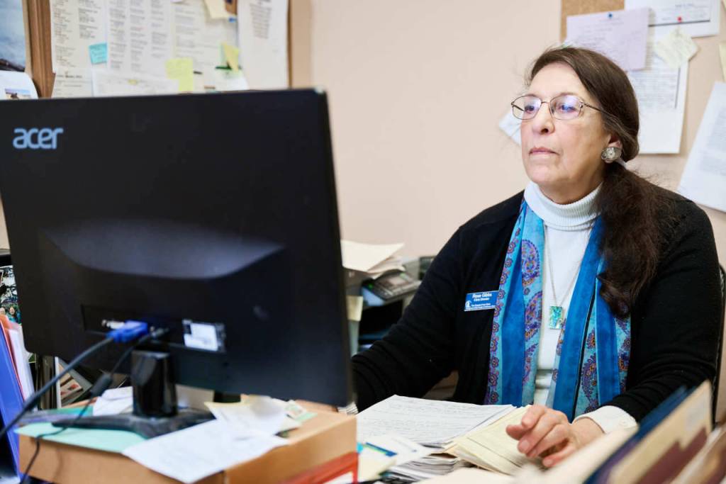 Rose Gibbs works on the computer in her office at Sequims Free Clinic. She has been clinic director there for 16 years.