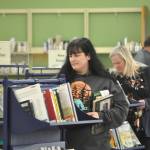 Sequim Gazette photos by Matthew Nash
Daughter and mother Acacia Bonura, left, and Nikki Bonura, right, both of Sequim, look for items to check out on the last full day of the Sequim Temporary Library being open. They visit the library a few times a week and said theyll likely return in February for holds until the renovated library reopens. Nikki said the library means a sense of community to her and its always a positive place to be.