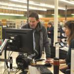 Sequim Gazette photo by Matthew Nash/
Christine Whitmarsh, public services specialist, helps patron Steve Lee answer a question on Saturday, Jan. 31 - the last day the Sequim Temporary Library was open for regular service. In February, its open 2 p.m.-5 p.m. Tuesdays, Thursdays, and Saturdays for holds and drop-offs.