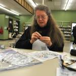 Sequim Gazette photo by Matthew Nash/
Maia Lacher of Sequim works on a cross stitch during the Yarn Circle weekly meeting on Jan. 31. She comes to the group every week in the winter, she said. It was the last program to occur in the temporary library before it closed as staff ready to move to the renovated library.