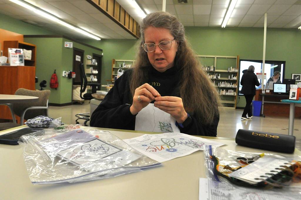 Sequim Gazette photo by Matthew Nash/
Maia Lacher of Sequim works on a cross stitch during the Yarn Circle weekly meeting on Jan. 31. She comes to the group every week in the winter, she said. It was the last program to occur in the temporary library before it closed as staff ready to move to the renovated library.